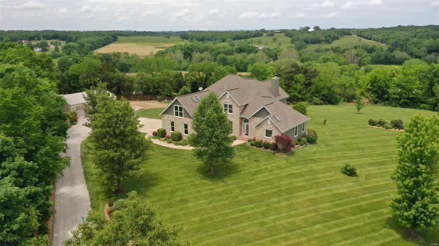 Rare opportunity to own recently rehabbed 1 1/2 story home sitting on private 4 acre lot in Washington MO. This home is country living at it's finest with gorgeous landscaping, million dollar views and perfectly maintained lawn. Exterior of home was just completed with Diamond coated siding with 50 year warranty. 3 car detached garage recently added for all your storage needs. Home boast soaring vaulted ceilings and new flooring thru out main level. Kitchen is updated with professionally painted cabinets, stainless steel appliances and granite countertops. Great room equipped with gorgeous floor to ceiling stone gas fireplace and custom oversized new Pella windows. Main Floor master is spacious with brand new master bath with dual granite vanities and 2 person jacuzzi tub with walk in shower. 3 Freshly painted bedrooms and loft overlook great room upstairs. Lower level has updated wet bar and large family/rec room. Additional full bath and ample storage area completes lower level.