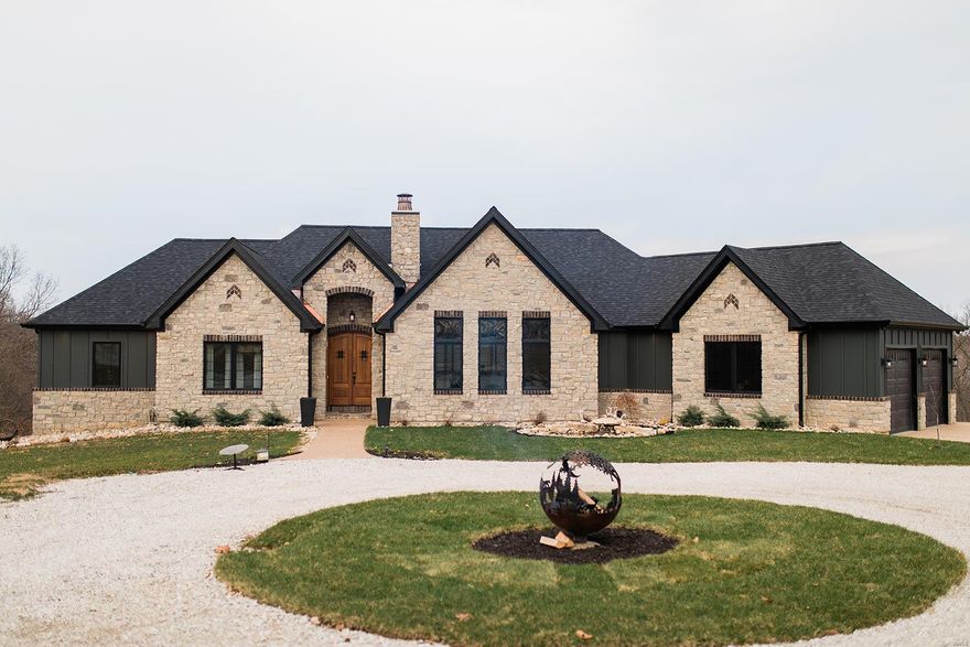 This one-of-a-kind custom home was built in 2021 & is a timeless blend of style - the warmth of a rustic farmhouse & the elegant features of today's most modern homes. Entering the massive mahogany front door, you will immediately recognize the attention to detail & custom features throughout this 4,000+ sqft home. Decorative wood truss beams, tongue & groove ceilings, coffered ceilings, stone FP, hand hewn beams, & premium engineered hardwood floors. The kitchen features distressed solid wood cabinets, granite countertops w/ rock face edging, copper sink, & GE Cafe' platinum finish appliances. The MBD is a great retreat w/ private access to the large 20x13 covered deck. The MBA features a 6' copper soaking tub & walkthrough shower w/ full body sprays. Let's not forget the theatre rm w/ 7-point surround, family rm w/ bar, extra bdrm, & safe rm. This timeless treasure is nestled on a hill overlooking a beautiful, wooded haven of 20 Ac m/l w/ creek, food plots, and home to much wildlife.
