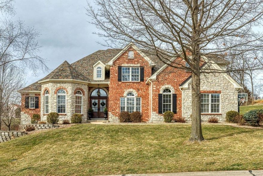 This spectacular European-inspired 1.5 Sty features an impressive brick & stone elevation enhanced by numerous offsets & roof lines to create amazing curb appeal. Vaulted 2-sty foyer leads to private study with built-in bookcases, elegant dining room & stunning great room with cast stone fireplace & dramatic wall of windows. Designer kitchen with 42” white cabinetry, quartz countertops, Viking appliances, 6’ center island & butler’s pantry adjoins light-filled breakfast room & hearth room highlighted by floor-to-ceiling stone fireplace. Coffered master bedroom suite with wide bay window & marble bath with freestanding tub provides an appealing retreat. The 2nd floor extends the living quarters with 4 additional bedrooms & 2 Jack n’ Jill baths. Lower Level includes recreation room with stacked stone fireplace, game room & kitchen plus office, workout room & full bath. Situated on a 1+ acre cul-de-sac lot with patio & resort style pool with waterfall surrounded by landscaped gardens.