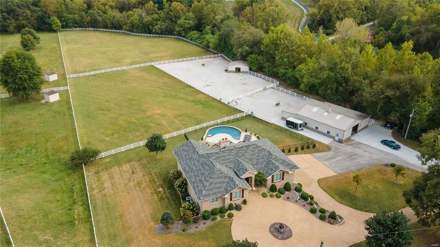 WOW LOOKING FOR THAT EQUESTRIAN PROPERTY THAT HAS IT ALL LOOK NO FURTHER! This beautifully updated walkout ranch overlooking a horse shoe shaped salt water pool with built-in wood burning fire pit and 5.7+/- acres of primarily all pasture. 2 Pastures, 2 dry lots, (2) outbuildings, 48x46 with (3)15x12 stalls and tack room. 20x30 Open span building. When you enter this beautiful ranch you walk into the open great room with a chef's dream updated kitchen white custom cabinets with double level large center island opening up into the breakfast room, dining room and covered deck all looking out onto the pastures and pool. The primary bath offers Quartz counters custom updated cabinets, separate shower and freestanding tub. The custom shelving in the primary closet are unbelievable. 4th Bedroom on main level has custom cabinets and built in desk. Lower level with fireplace, custom wet bar, Quartz counters ,5th bedroom and full bath. Must see!