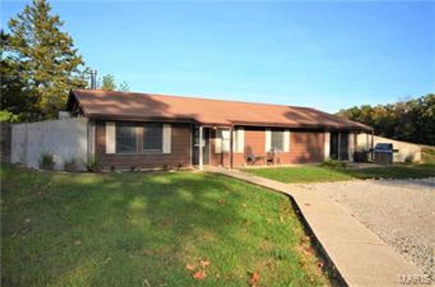Nestled on 11 acres with a pond is this 2 Bedroom Earth Contact home.  The Kitchen is newly updated and reconfigured.  There are custom wood cabinets, Pergo flooring, lots of counter space, breakfast bar and skylights.  The Living Room has a free standing wood burning stove and a great water view.  There is a large 2 car detached garage with a lean to and also a 24 x 12 Outbuilding that could be a workshop.  All of this on a private country setting, but just minutes from everything you need in town.  Schedule a showing to see everything this property has to offer.