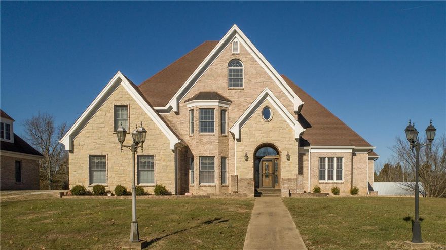 Lovely setting for this massive, brick/stone estate, sitting high among the woods. Wind down along the Bourbouse River, anticipating your 60 acres! Impressive construction, space, and energy efficiency were first in mind when this home was built. 2 story entry showcases the staircase, and open spaces to the right, left and ahead. Library opens to the master suite, flows to the great room, back steps, and kitchen. Butlers pantry opens to the dining room. Main floor family room is where most of family gatherings take place. 3 bedrooms on the upper floor, one en-suite bath, and a Jack and Jill bath. Balcony opens to the great room below. The LL is partially finished with a full and a half bath. 3rd floor offers a perfect office, hobby room, or kids playhouse! 2 Geothermal units, 3 hot water tanks, 2 water heaters. 2 story 40x70 outbuilding with finished upper level for an enormous work shop. Detached garage also offers 2nd floor and loft. Selling in present condition to settle the estate