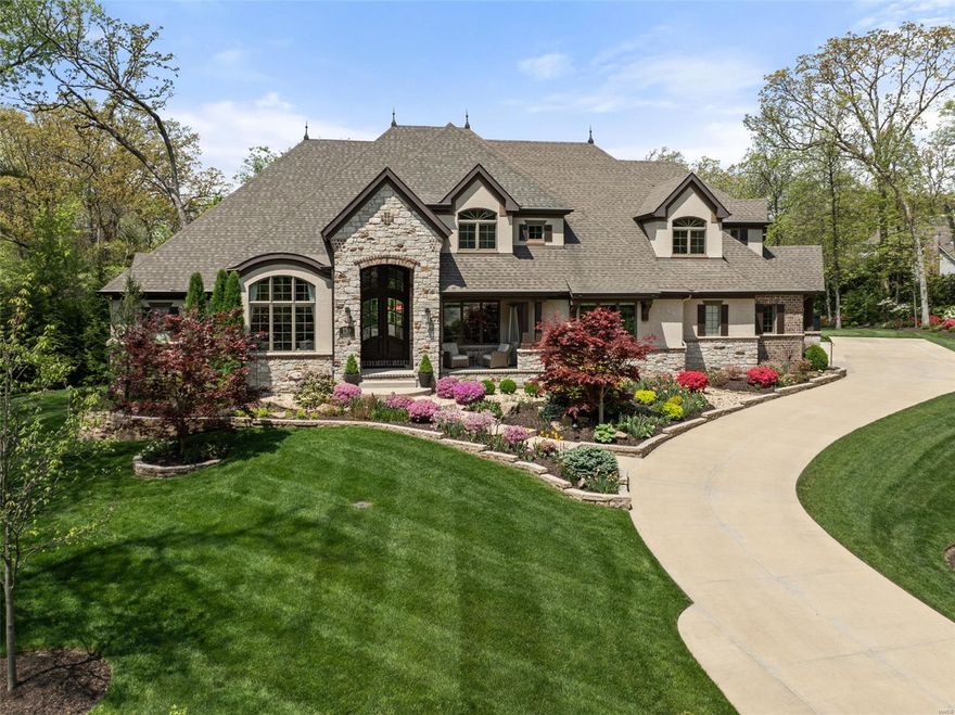 Luxury, privacy, and impeccable design converge in this 6-bed, 8-bath home on a secluded 1-acre lot in Frontenac. A grand two-story foyer is flanked by a private office with custom built-ins and a formal dining room. The heart of the home is the vaulted great room with soaring beamed ceilings, striking stone fireplace, and custom built-ins, seamlessly flowing into the luxurious kitchen with custom cabinetry and high-end appliances. Off the kitchen, a four-season sunroom with fireplace overlooks the backyard. The main level also features a spacious primary suite with spa-like bath and 2 walk-in closets, additional guest suite, laundry, mudroom, and access to the 4-car garage. Upstairs, you’ll find a bonus area, three generously sized en-suite bedrooms and a second laundry. The walkout lower level is an entertainer’s dream with a rec room, wet bar, custom wine cellar and bedroom en-suite. Outside, a custom pool with waterfall, relaxing spa, and fire pit create the perfect private oasis. Additional Rooms: Wine Cellar