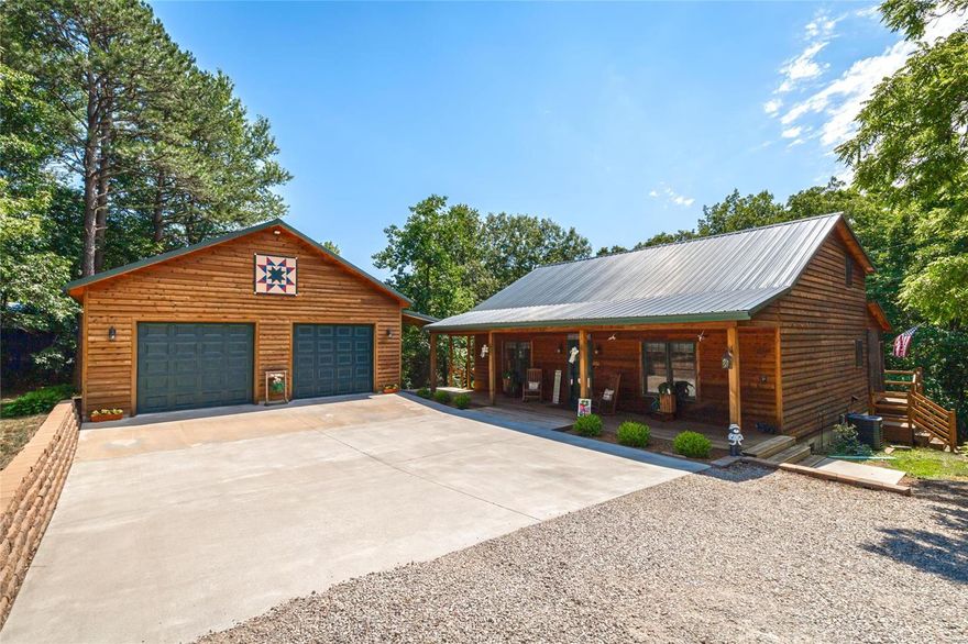 This one of a kind Cabin is a great place to sit and relax.  Off the highway and backs up to the woods with a screened in porch.  Great fireplace to sit and relax on cold winter mornings.  A hug loft space upstairs for an office or bedroom with its own heat. The master bath leads out to a screen in porch facing the woods.
The 2 car garage has power and would make a great place to park your boat or make a workshop.  The setting is gorgeous and a home you could retire in.