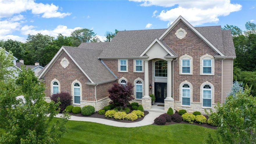 Why wait to build? Marvel at this magnificent better-than-new 1.5 story, 5200 sq ft home. Quiet enclave of executive homes. Impeccable attention to detail w/countless upgrades."Elegante" iron & glass front doors unveil a grand foyer, iron-spindle staircase, extensive millwork, 9ft ceilings/8ft doors, plantation shutters & job-finished wood floors. Expanded great rm w/gas fp & floor-to-ceiling windows showcase splendid views. Well-appointed kitchen leaves nothing to desire; center island w/double-stacked granite, gas cooktop, double convection ovens, built-in refrigerator, walk-in pantry & breakfast rm. Vaulted hearth rm w/gas fp leads to patio & large yard backing to wooded common ground. Relaxing main floor master suite w/spa-like bath; dual sinks, soaker tub, shower w/dual controls & heated tile flr. Upper bonus family rm w/surround sound. Fabulous amenities for living & entertaining: oversized 4-car garage, main floor laundry, multi-room audio system, landscape lighting & much more.