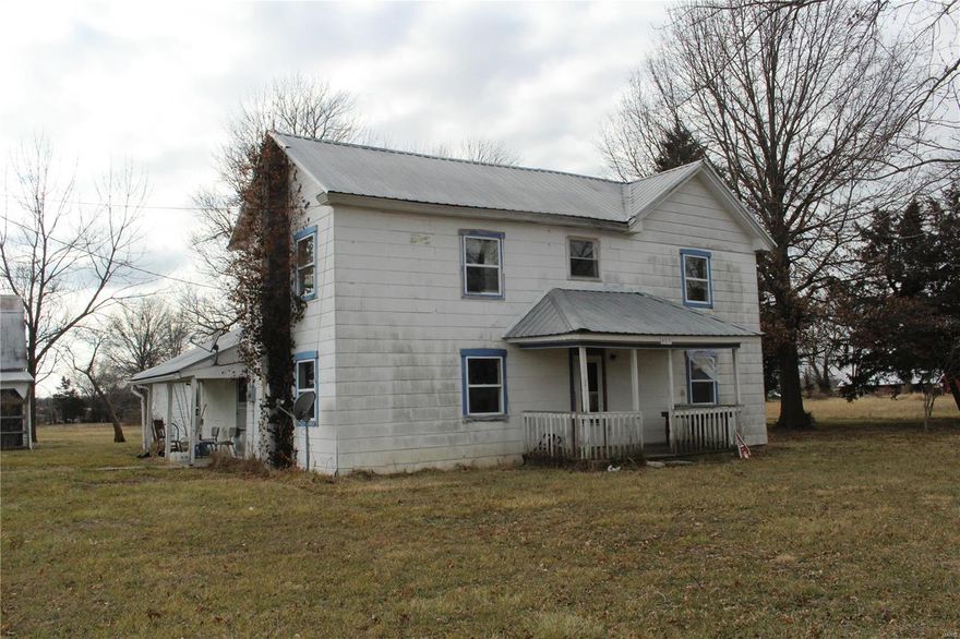 This charming homestead on the outskirts of town needs some TLC to make it a warm, comfortable home for a new family, but it has so much to offer already! Situated in a rural atmosphere it has been partially updated with tilt-in vinyl windows, an updated electrical panel, newer furnace and metal roofing.  All rooms are spacious and have built-in closet space and lighted ceiling fans.  The carpet has been removed from one bedroom and exposed the original hardwood floors!  The house has an attached 1-car garage that could be returned to a 2-car garage.  The 40'x26' barn has electric, concrete and doors on each side for easy access and removal of large machinery.  Offered by the seller As-Is.  Inspections welcome at buyer's expense.  Call today for your private showing.