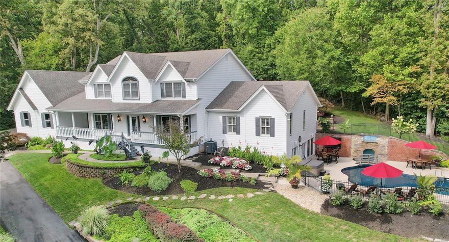 Secluded on over 3 acres with a park-like ambiance and breathtaking views, this stunning home offers a personal slice of heaven. A welcoming front porch overlooks the large pond and is a precurser of this special home with 7,000+ SqFt of living area. The elegant foyer is flanked by a formal dining room and a stately office, both showcasing rich millwork including a box-beam ceiling. The sleek kitchen will delight any chef, featuring custom cabinetry, granite countertops, and high-end appliances with access to the breakfast room with built-in shelving and the cheerful sunroom. The Main Floor Master suite is a luxurious retreat with a spa-like bath and custom his-and-her walk-in closets. The expansive family room boasts a cozy fireplace, while upstairs, four spacious bedrooms and two full baths await. The lower level is entertainment central, complete with a wet bar, fireplace, billiard room, and french doors to the unbelievable pool complex. Private and quiet, but close to everything! Additional Rooms: Sun Room