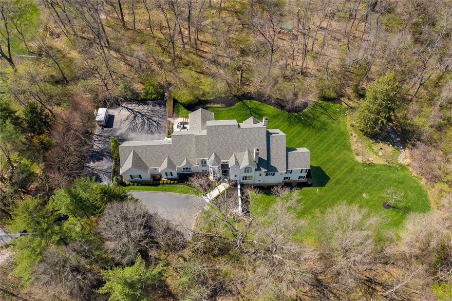 The ultimate in privacy and situated in one of the most coveted areas of Ladue, this 4 plus bed, 5 full/2 half ba home offers the best of modern design and picturesque outdoor spaces.  Lg windows and walls of glass doors flood this home with natural light even on a cloudy day.  The open concept updated kitchen with soaring ceiling, and center island flows seamlessly to a breakfast area and family area with access to a 3 sided screened outdoor liv rm.  The main flr master suite with newly renovated luxury bath offers his/her closets and a private screened porch perfect for those quiet nights at home.  A wood paneled den with fp, liv rm with beamed ceiling, din rm with custom temp controlled wine display, 2 half ba and laundry rm complete the first flr.  3 bedrm suites with walk in custom closets and updated baths are found on the second flr.  The walkout low lev offers additional family space, full updated ba, a custom office and tons of glass doors to the gorgeous landscaped yard.