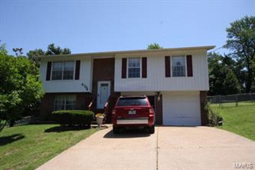 Move in ready home on quiet, peaceful street.   Gleaming hardwoods welcome you as you ascend the stairs and enter the living room.  Newer flooring also in the kitchen and dining area.  Freshly painted exterior.   Plenty of space for a large table.  Step outside and sitting on the covered porch overlooking the park-like setting in the backyard.  Ceiling fans in each of the 3 bedrooms.  Showers in each of the 3 bathrooms (tub in the hall bath).  Rec area in the lower level (could be converted to bedroom).  Furnace installed Sep 2012.  Newer roof, newer carpeting, updated bathrooms.  Newer spring on garage door!  Well maintained home ready for new owners.  Come in and see!