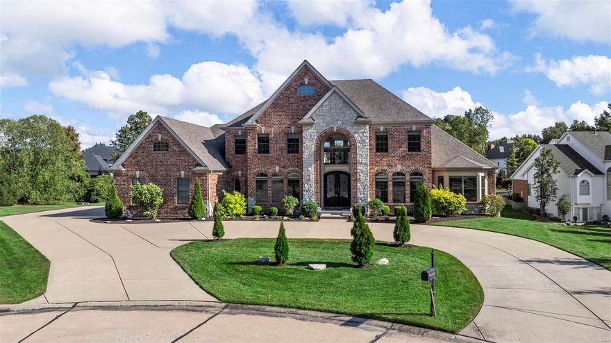 Beautifully-designed 1.5-sty estate in a premier Town&Country gated enclave of only seven homes! 2-Sty arched entry w/ extraordinary wrought iron double doors leads to grand foyer highlighted by dramatic curved staircase, elegant office space, dining room & spectacular great room w/ barrel-vaulted hall, marble fireplace, wet bar & 2-sty wall of windows. Spacious kitchen w/granite countertops, 42” cabinetry, stainless appliances, 9’ center island & butler’s pantry adjoins light-filled breakfast room with atrium door to deck & vaulted hearth room with floor-to-ceiling stone fireplace. Coffered master bedroom suite with bay window, 2 walk-in closets & lavish bath offers an appealing retreat. Front & rear staircases access 3 generous bedroom suites plus bonus room. Expansive walk-out Lower Level includes huge rec room, game room, + bonus room great for bedroom, office or gym.  Situated at the end of the cul-de-sac on .76 ac grounds with deck, covered patio, circle drive & 3-car garage.