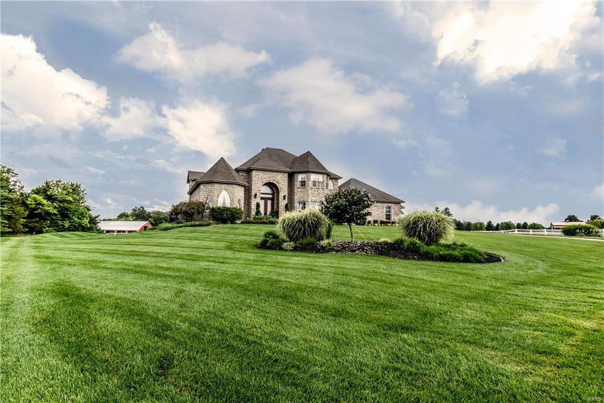 Stunning luxury horse property located in the Foristell/New Melle area within the Francis Howell School District! 9+ acres w/over 7000 sq. ft. total living space including 5 bedrooms & 5 1/2 baths. Recent $100,000 Kitchen remodel is a chef's dream! Some of the features are the over-sized granite island, sub zero refrigerator, separate beverage fridge, award winning viking hood/stove, & pot-filler. Walk-out Finished Lower Level w/wet bar, rec area, bedroom w/2 full baths & office area. Huge salt water pool w/slide! Master suite on main level w/coffered ceiling, bay window & turret ceiling. Upper level has open loft area & 3 additional bedrooms all w/walk-in closets. Coffered ceilings, crown molding, 3 car garage w/over-sized 3rd bay for larger vehicle. The upgrades are unlimited and a truly must see. Brick front barn w/10 stalls, washing bay, tack room, & hayloft. Vinyl fencing around majority of acres w/horse arena.
1-Year HMS Home Warranty!