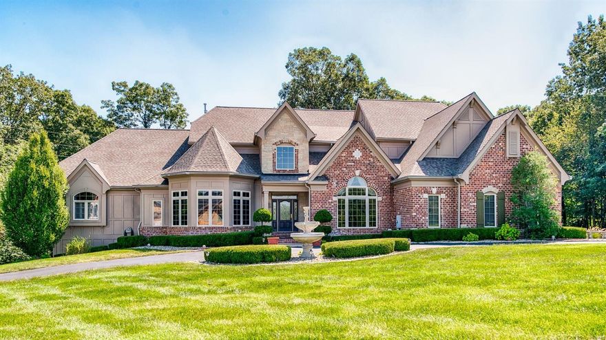 This immaculate custom-built 1.5-story home boasts over 7,000 sq.ft. of living space. The main level offers a sophisticated office w/ box beam millwork, dining room with vaulted ceilings, a bright 2-story great room with floor-to-ceiling windows, gorgeous eat-in kitchen w/ solid wood cabinetry, large center island and a hearth room w/ vaulted ceilings. A spacious primary bedroom suite w/ bay window, coffered ceiling, massive closet w/ organization system and an airy primary bathroom w/ huge shower and soaking tub. Upstairs offers 3 spacious bedrooms w/ large walk-in closets. The walk-out lower level includes a fun rec space with bar, soundproofed theater, spacious gym, a full-bath w/ steam shower and a bedroom opportunity. Outside boasts a large composite deck, patio w/ fire pit surrounded by the privacy of mature trees. The oversized 4-car garage is sure to impress. All of this and more is appointed beautifully on a level (yes, its not often you hear that word in Wildwood) 3-acre lot.