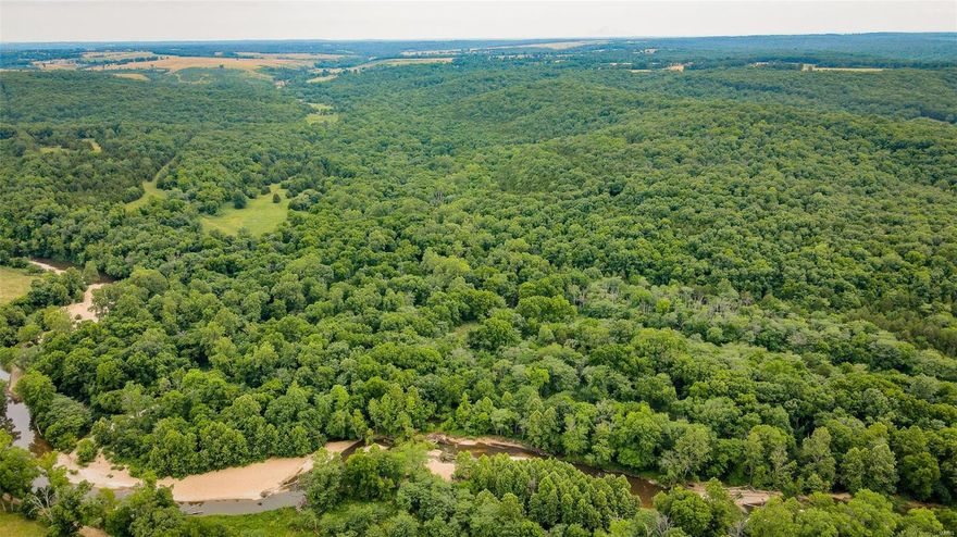 516 +/- acre farm located in Texas County, Missouri. An outdoorsman’s dream. Your very own road leads you back off the beaten path, to your peaceful and secluded land that dreams are made of. Massive blocks of mature timber surround its lush bottom ground that sits along over 2 miles of the spring fed Roubidoux Creek and Burkhart Branch combined. Aside from the large bottom ground fields there are multiple smaller clearings that set up for food plot scenarios scattered throughout the property. Everywhere you look you will be surrounded by tremendous habitat, and trail systems that run through the property.There are 2 springs on the property, and multiple wet weather creeks. Many mature walnut, white oak, and black oak tower throughout. The banks of the Roubidoux allow for great river fun for the whole family. This amazing farm literally has it all; tremendous hunting, fishing, hay production opportunity, and farming if one desired, allowing for great opportunities for its new owners.