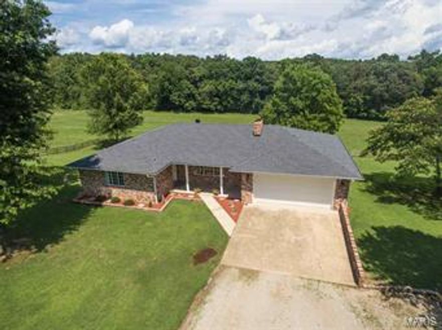 Enjoy country living at its finest w/this well maintained 3310 sq ft all brick home on 21 acres just north of PB city limits!4 BR 2.75 bath w/full finished walk-out basement, hardwood/tile/carpet floors,open floor plan,large kitchen w/dishwasher,microhood,double oven,breakfast bar & spacious dining room combo!Two gas fireplaces,walk-in tile shower,back deck,covered patio,covered porch and more!!The 21 acres is fenced & includes a 4 stall barn,2 storage sheds,2 metal carports & 335ft of cane creek frontage.