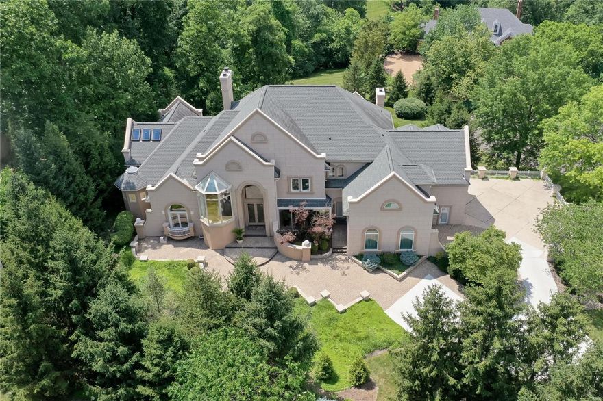 Magnificent. Modern Luxury on a very private cul-de-sac of 3 homes in Town and Country. 5 bedrooms, 9 baths, and over 9,500 square feet of refined living area. Hallmarks are an open concept with abundant glass and skylights. A main level primary suite walks out to a deck overlooking the pool, and enjoys an expansive bath with vaulted ceiling, jet tub, oversized shower and dual walk in organized closets. A two-story great room captures outstanding views. The chef's kitchen with island employs high end appliances, granite counters,  and opens to hearth and breakfast rooms. A two story water feature is a main focal point, with a 2nd stairwell servicing all levels wrapped around a pillar of cascading water. 2nd level has 4 bedrooms all en-suite. Above grade walk-out lower level features media and game rooms, additional sleeping area, and home office, as well as 2 full baths, one with steam shower. 1.27 acre lot. Steps away from popular Longview Farm Park and Masonridge Elementary school.