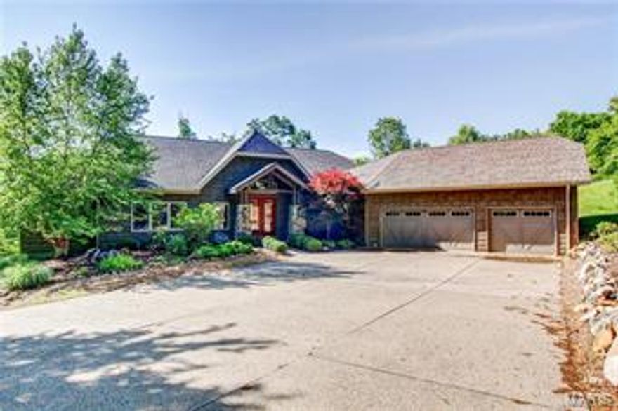 The search for a stunning lake home close to St. Louis is over. This is it! This home radiates charm. Beginning with excellent curb appeal. An aggregate driveway, stone accents, shake siding, barn-style garage doors, and eye-catching landscaping draw you in. Upon entering you'll be wowed by the vaulted ceiling, massive wall of windows, floor-to-ceiling stone fireplace, and impressive view of the lake. The gourmet kitchen is open to the great room and features granite tops, custom cabinets, and designer appliances. The master bedroom suite includes lake views, walk-in closet, office/den, and a bath with walk-in shower, soaking tub, and double sinks. The lower level has room for all your guests: 3 beds and 2 baths plus a family room. Appreciate the outdoors from the screened porch, low maintenance deck, or patio. The property has over 5 acres of Missouri hardwoods. The koi pond, lake frontage on Alpine, abounding wildlife, and maximum privacy make this a must-see! All furniture included!