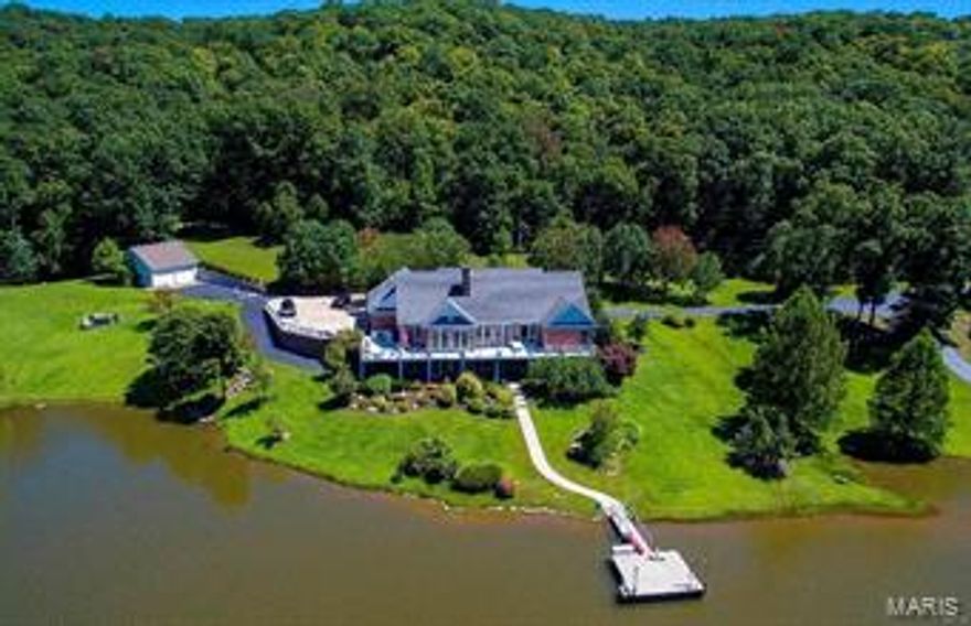 412 AC COUNTRY ESTATE 45 MIN. WEST OF ST.LOUIS. 5000+sq ft home looking over 24 AC sparkling stocked lake w/ walkway to lighted dock. This private, valley setting is sure to please. This 13 room home features ground source heat pump, 10 ft ceilings, exquisite moldings & gorgeous, solid wood flooring plus some T&G, wood vaulted ceilings. Full length deck offers great entertainment space off the spacious, well-appointed kitchen & unparalleled view of the lake. Lower level offers huge recreation area, card room, bar, family room, & double sided stone fireplace. Endless valley trails including a path to an early Native American cliff cave & sandstone overhang. Creek meanders thru valley, expansive pasture/hay fields. State Of The Art 10 stall horse barn wash rack, tack room, large office, kitchen & lounge. 12x12 stalls 2 foaling stalls, 6 turnout runs & 4 large, horse safe fenced pastures w/ auto waterers. In addition, 40x80 machine storage w/ concrete floors & auto doors large hay barn.