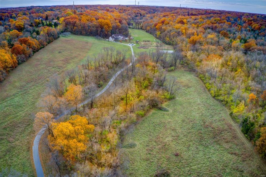 Enjoy ur own private piece of paradise in Wildwood! 36.979+/-acres rolling hills & flat pastureland w/7 bdrm, 6½ baths, 3-car attached & 2-car detached garage. Tranquil drive along the tree-lined driveway to the classic, spacious 5,200+/- sqft, 2stry home nestled at the top of a hill which has been loved & maintained by 1family. Recently refinished gleaming hardwd flrs thru-out most of home. ML boasts a fam rm w/a brick surround FP &built-ins, dining rm, eat-in kitchen, 1/2 bath, screened-in porch & mother-in-law wing:2 bedrms, each w/en-suite bath, &1 w/W/D hookups, its own separate kitchen, &office. UL you will find 5 generous bdrms all w/wd flrs. MS w/HUGE WI closet & bath w/dble sinks .4 add'l bdrms share hall bath. Sleeping area w/ensuite bath & laundry complete UL. Attic area potential for add'l living space. Unfinished, WOLL w/full bath.New stone coated steel roof w/venting system 2020. Energy efficient &eco friendly solar panels.ADA ramps @front door &screened-in porch door.
