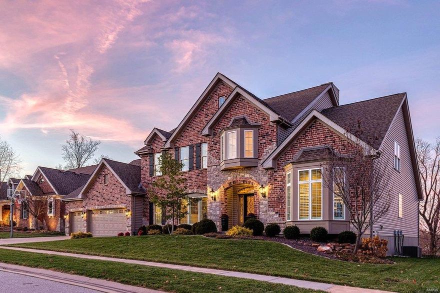 Beautifully designed brick & stone 1.5 Sty from DH Custom Homes. 2-Sty hardwood foyer highlighted by dramatic flared staircase leads to private study with French doors, elegant dining room framed by arched entryways & stunning great room with granite bar, marble fireplace flanked by built-in bookcases & wall of windows with private wooded views. Spacious open kitchen featuring granite countertops, staggered cabinetry, 11’ center island & butler’s pantry adjoins breakfast room that opens to deck & hearth room with stone fireplace & convenient planning center. Coffered master bedroom suite with luxury bath offers an appealing retreat. The 2nd floor extends the living quarters with 3 additional bedrooms, 1 with ensuite bath & 2 with Jack n’ Jill bath, & bonus room. Lower Level includes recreation room with quartz bar, game room, family room & 1/2 bath. Premium cul-de-sac lot with covered patio & paver stone patio with firepit. Dardenne Greenway is just a short walk or bike ride away.