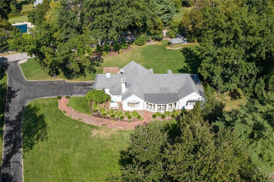 Fabulous opportunity to rehab a cottage home build in 1939 and owned by one family, or build your dream home on this private 1.95 acre lot in the heart of Ladue located off Price Road. The property features beautiful mature trees and plantings is quite and serene with rolling green space offering a phenomenal setting for new construction. Home is being sold "as is" and seller will make no repairs or improvements or pay for inspections. Please submit offers on a special sale contract. Supra on front door. See duplicate listing #20072307