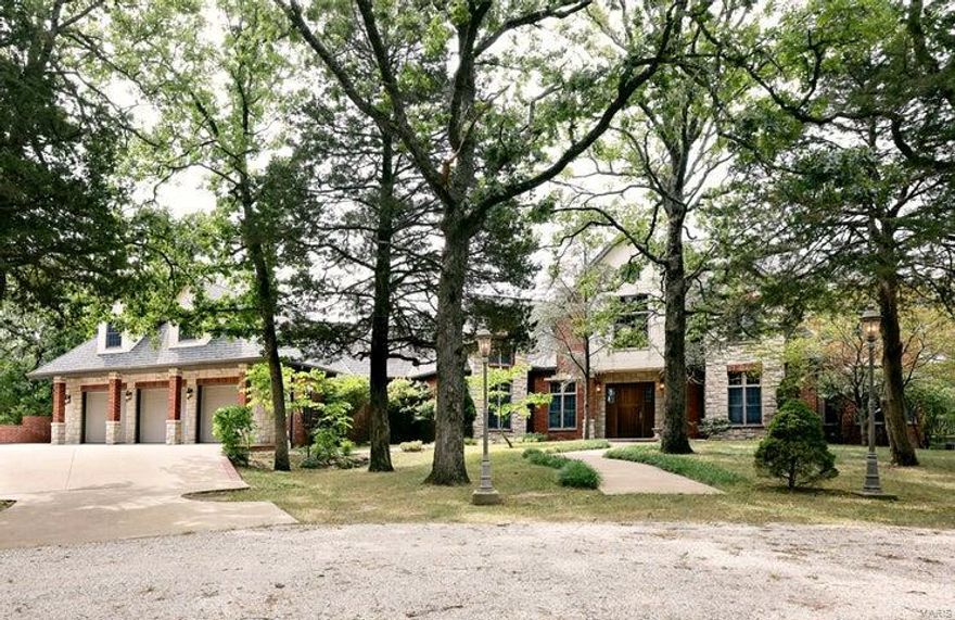 This large European style home is ideally situated on a wooded hilltop. Custom built features include; hand-cut stone and brick, gated entrance, in-ground pool w/automatic cover, large composite decks, screened-in porch serving the master bedroom, new architectural roof, 3-car garage, shop, landscape watering system, and more. Inside you will find 6 bedrooms, 8 ½ baths, 7 fireplaces,3 kitchens, handmade doors, cabinets, and trim, antique stained glass, Andersen doors and windows, granite countertops, central vacuum, sewing/craft room, and all the cool stuff. An elevator serves all three floors along with accessibility designed throughout. This home was built for comfort and ease of maintenance but also great for large gatherings in a private setting. Perfect for multi-generational or extended family. Property has great access to I-44 and is offered with 33 acres with more land available. Seller and seller's (son), agent, are both licensed Real Estate agents in the state of MO. Some Accessible Features