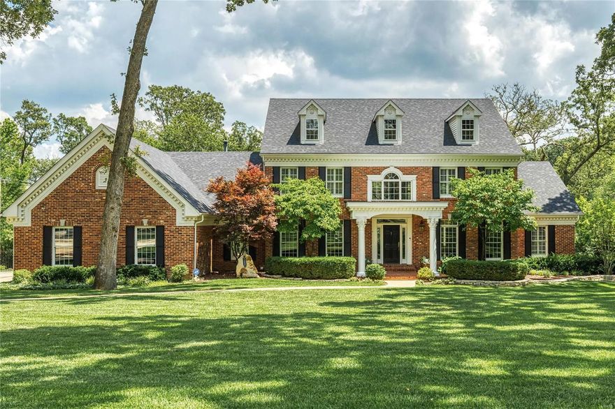 Magnificent 1.5-sty Georgian Colonial on parklike 1-acre grounds! Impressive 2-sty foyer highlighted by dramatic curved staircase leads to library-paneled study with built-in bookcases, elegant dining room & stunning great room with marble fireplace, wet bar & 2-sty wall of windows. Designer kitchen with 42” cherry cabinetry, granite countertops, premium appliances & convenient planning center adjoins light-filled breakfast room with atrium door to deck & vaulted hearth room with floor-to-ceiling stone fireplace. Coffered master bedroom suite offers a relaxing retreat with His & Hers walk-in closets & beautifully appointed bath with jetted tub. Front & rear staircases access 3 additional bedrooms, 1 with ensuite bath & 2 with Jack n’ Jill bath. Lower Level includes recreation room with fireplace, game room, wet bar, 5th bedroom & full bath. Atrium door opens to outdoor living area with grilling station, resort style pool, hot tub & patio with fireplace surrounded by landscaped gardens.