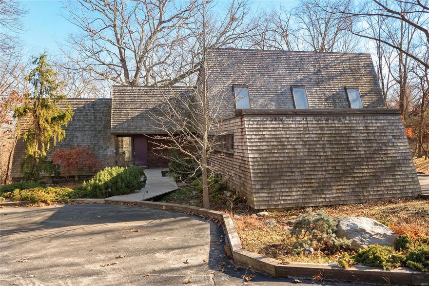 Welcome to a remarkable contemporary house nestled amidst the beauty of a wooded 3.65-acre lot in Town and Country. Upon entering, you'll be captivated by the thoughtful design, which ensures that every room captures views of the outside, connecting you to nature in every room. The main floor boasts a primary bedroom suite with enormous picture windows. The living room is a masterpiece of design, featuring floor-to-ceiling windows that offer another ever-changing panorama of the picturesque woods, a massive fireplace, and a hidden wet bar. The kitchen features custom white cabinets, a Subzero fridge, large windows and a door leading to the wrap-around deck. Open to the kitchen, you'll find a dining room. Main floor laundry. Upstairs, discover 3 bedrooms, and a full bath. The finished walk-out lower level adds even more living space, complete with another bedroom, full bath, vast recreation room, and storage. 2-car garage. Close to Queeny Park.