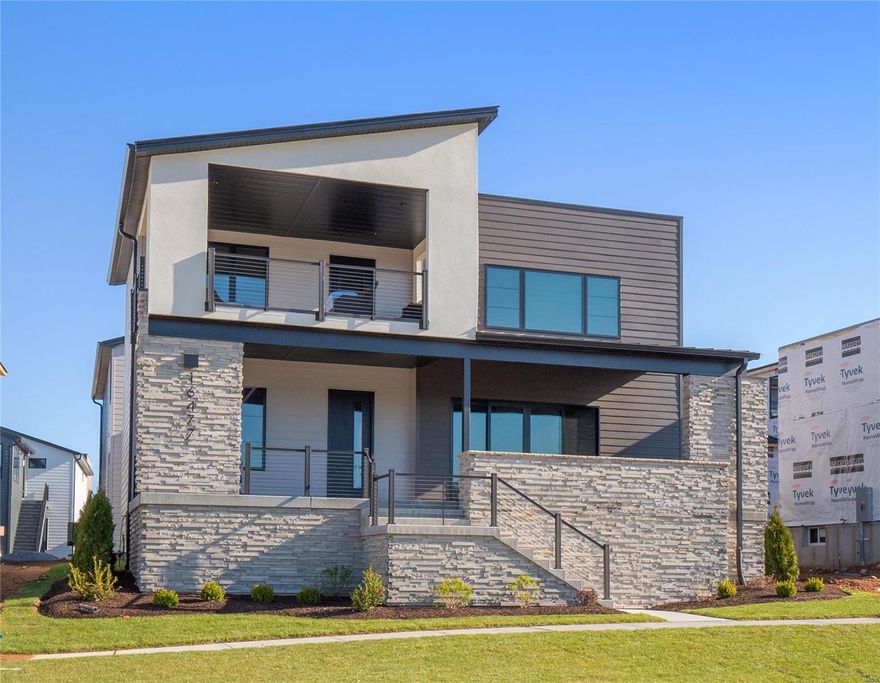 Nestled in the newly unveiled Waterfront at Wildhorse Village, this exquisite 6-bedroom, 4.5-bathroom residence epitomizes luxury & meticulous design, offering an impeccable fusion of indoor & outdoor living. The welcoming open floor layout introduces a private office space, a chef's dream kitchen with top-tier appliances & a concealed prep area, alongside a guest suite with a full bath, and an additional bedroom on the ground floor. Ascend to a serene upper level featuring a cozy loft, a grand primary suite with an opulent ensuite & a private balcony with lake views, plus a separate apartment ideal for in-laws or teens, equipped with a kitchen, living space, bedroom, bath, and its own entrance. Two more bedrooms & a bathroom complete this level. With a three-car garage & prime location near walking paths, premier dining, entertainment, and the dynamic Chesterfield Entertainment District, this home isn't just a dwelling—it's a lifestyle of unparalleled luxury, comfort, & convenience.