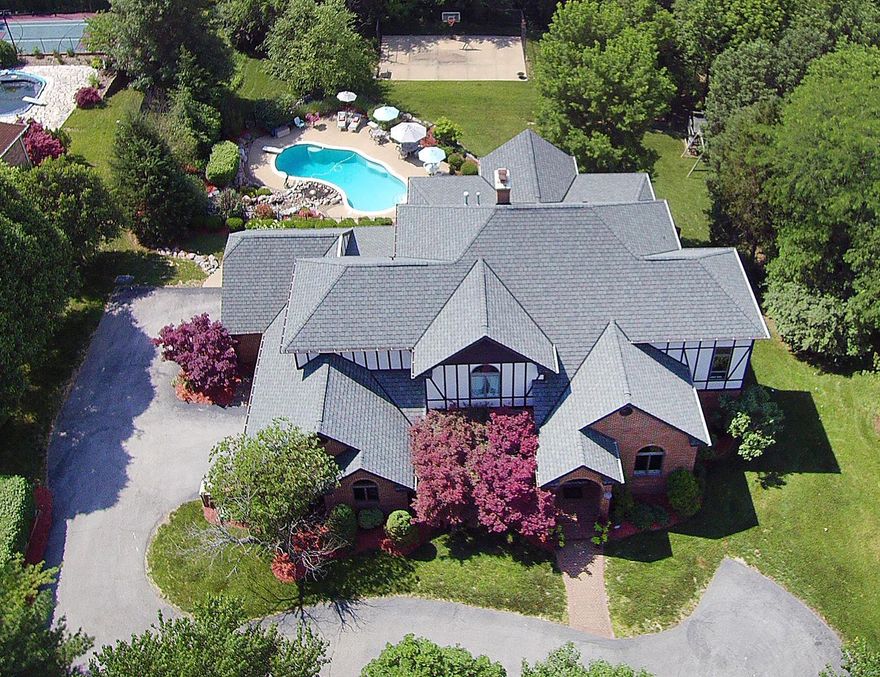 Drama, character, individuality, SOARING (9’-20’+) dimensional ceilings, 3 sty atrium! Recent major upscale renovations with Old World charm & luxury! Vestibule entry opens to foyer w travertine flooring that flows into kitchen & breakfast room. Hardwood flooring thru out rest of ML & 2nd flr. Dining room w coffered ceiling & built-in cabinetry, living rm/den off entry. Kitchen w upscale appliances, large built-in breakfast nook, great center island, farmhouse sink, a notable laundry/mud rm area w built ins, family rm w 25’+ ceiling & fireplace. Midway up is exec office staged by custom leaded glass antique French doors. UL w luxurious master suite w huge closet plus 2 other bedroom suites. Finished LL w bed & bath, separate game rm/theatre rm & more. All levels open to 3 sty atrium w fountain & feel of tropical paradise & more “rooms”. Private backyard, inground pool, sports court, pond/waterfall, 4 car gar. SEE PHOTOS for more details. Additional Rooms: Sun Room