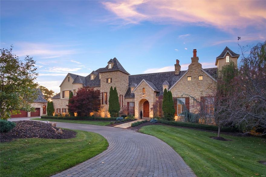 A resplendent three acre estate perched atop the highest and most coveted bluff in St. Albans. This Dick Busch-designed masterpiece offers breathtaking views of the Missouri River Valley. A palatial great room with a stone fireplace and 30' beamed ceiling welcome you to this chateau-style estate. The gourmet kitchen is appointed with custom cabinetry, top-of-the-line appliances, wine closet, center island and a butler's pantry. Adjoining the kitchen is the hearth room featuring a stone fireplace, a wall of windows and access to a covered terrace & patio. The main-level primary suite features a spa-like shower, Jacuzzi tub and a steam room. Upstairs are 3 ensuite bedrooms and  generous loft area. The walkout LL is beyond compare with bar, fireplace, game room, family room, office and 2 addl bedrooms. A three-car attached garage is supplemented by 4 addl spaces below the carriage house which boasts a full apartment. An infinity pool, hot tub & tee box round out this magnificent property. Additional Rooms: Mud Room