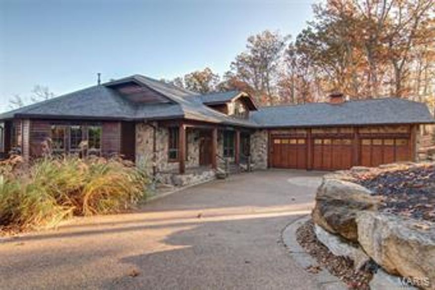 Jaws will drop at the sight of this majestic lakeside estate, covered in wood from top to bottom, a luxury lodge on Alpine Lake.  The soaring ceilings coupled with the corner stone fireplace towers over the great room, drawing your attention to the large windows and a picture perfect view. 

Family is never far away in this home with its enviable, completely open floor plan. A gourmet kitchen overlooks the great room and features a breakfast bar, custom cabinets and granite counter tops. The entire home is finished with logs, cedar and stone, giving it a true "lake lodge" feel.  Every room was professionally decorated to be warm and inviting.  

Other features of the home include a wine cellar, elevator from the great room to the lower level, glassed in four seasons room, screened porch. The walkway from the lower level leads you to a flagstone patio featuring a stone wall in the backdrop coupled with a scenic view of Alpine Lake. 

This home is offered as a turn-key package. Additional Rooms: Mud Room