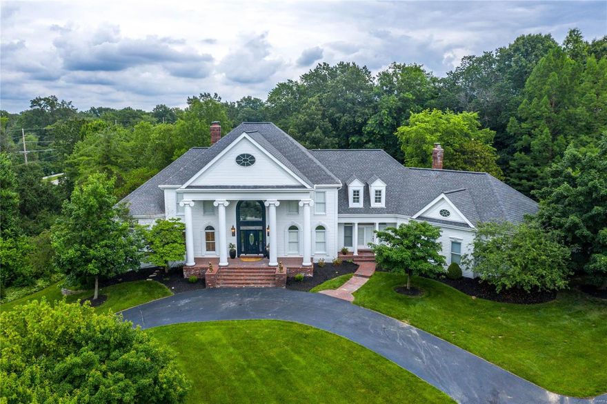This Johnson-built Southern Colonial w/7362 sq ft of living space exemplifies classic architecture w/a fresh perspective. Grand 2-sty marble foyer opens to library-paneled study, elegant dining room & spectacular great room w/fireplace & full-height mantel, built-in bookcases, wet bar & dramatic wall of windows.  Designer kitchen featuring 42” white cabinetry, quartz countertops, Thermador appliances & butler’s pantry adjoins light-filled breakfast room w/wide bay window & vaulted hearth room with floor-to-ceiling brick fireplace. Coffered master bedroom suite & beautifully appointed marble bath w/freestanding tub offer an appealing retreat. T-staircase accesses 3 additional bedrooms, 1 w/ensuite bath & 2 with Jack n’ Jill bath. Lower Level includes recreation room w/ fireplace, billiards room & media room plus 2nd kitchen, workout room & full bath. Atrium doors open to outdoor living area w/paver patios & resort style pool w/waterfall surrounded by landscaped gardens.
