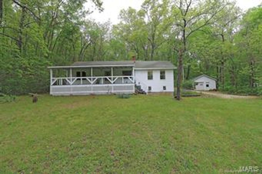 Looking for a private home in Coffman?  It is here and will not last!!!  A cozy home on over 4 acres w/ 2 Beds & a possible 3rd Bed & 1 AMAZING Full Bath.  Home sets on a full walk-out basement with a trendy updated kitchen that is a must see!!!  Granite countertops in kitchen and bath along with Hardwood floors all throughout.  All Electric with a wood stove for backup or lower utilities.  Spacious covered front porch for BBQ's and family gatherings or rocking in your favorite chair on lazy afternoons.  Home also has a lengthy covered back patio and a detached garage with a poured concrete floor and electric... Sealing your wishes for this property.  Hurry and call today!!!