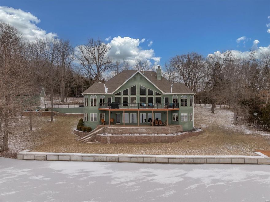 Step into this stunning 4-bedroom, 3-full bath, 2,1/2 bath lakeside oasis. From the moment you enter, be captivated by an open floor plan and a breathtaking wall of floor-to-ceiling windows showcasing panoramic views of Lake Quail. The formal dining room features a custom shiplap ceiling, adding a touch of elegance. The great room boasts vaulted ceilings and a stoned gas fireplace, perfect for cozy evenings. Stunning Kitchen with oversized center island, granite countertops, and beautiful cabinetry. Enjoy meals with a view in the breakfast area or step out to the maintenance-free composite deck. The main-level primary suite offers serene lake views, an en-suite bathroom, and an office area with the same stunning vistas. The finished LL features a second living area, a full stone woodburning fire place mini kitchen, 3 bedrooms, 2 full baths . Outdoors, enjoy an oversized deck, covered patio, fire pit, attached garage and separate detached.  Lakeside luxury at its finest! Additional Rooms: Mud Room