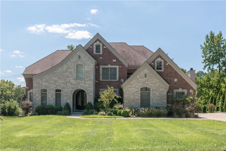 Custom 1.5 story on extensively landscaped lot*Design features an arched iron entry door, lovely millwork, architectural ceilings, 2 FP*Vaulted libr w/frosted doors*Elegant DR w/coffered ceiling & indirect lighting*Butler’s pantry w/wine cooler*The GR has built-in bookcases, ceiling fan, gas FP & a wall of windows*Fabulous kitchen w/gas cooktop, stainless appliances, granite counters, prep sink & spacious island opening to the brkfst rm & hearth rm*Light filled vaulted hearth rm w/stone FP*Main flr MBR: coffered ceiling w/indirect lighting & bay window*Mbath: 2 walk-in closets, his/her vanities, heated floors, whirlpool & seamless shower*  Upstairs: media rm w/coffered ceiling, 3 BRs, 1 private bath & 1 Jack&Jill bath*Walk-in closets*Additionally: Patio, water feature, 3 car side entry garage, sprinkler sys, deep basement pour w/look-out windows & rough-in plumbing, security sys, iron railing & a custom runner on the stairs. Outstanding convenient location! Ladue Schools!