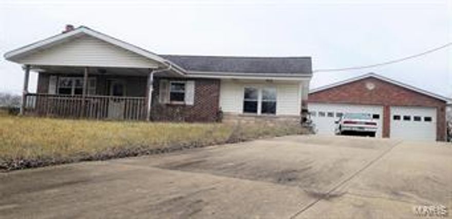 2 bed, 1 bath home located on little over half an acre.  Living room offers great gas fireplace for those cold evenings.  Nice open kitchen with crown molding.  Covered front porch.  44x30 garage for all your toys or that place to escape.  Garage is drywalled, small kitchen area, full bath, ceiling fans, washer dryer hook up and more.  Great property for needing a little TLC and will make a great home with amazing garage and nice property.  Come take a look today!!