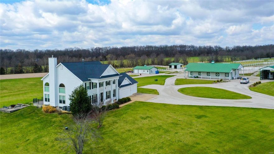 This exceptional equestrian estate is sure to impress! Stately 3,200/SF 2-story home with gated entry that is nestled upon 36.58 acres of vinyl fenced pastures. The property features a state of the art 7-stall horse barn with attached hay storage, 12x18 tack room, bathroom/laundry facility, wash stall, automatic heated waterers and rubber paver tiles in the aisle.  There are 3 all weather paddocks, 3 fenced grass pastures, run in sheds and automatic heated field waterers, and a 120x220 all-weather riding arena. The elegant 2 story home has 3 bedrooms, 4 baths, a 2-story great room with a gas fireplace featuring a customized mantle with horses jumping and a slate inlay.  There is an additional barn for trailer storage and a detached oversized 2-car garage. Also included in the sale is a 1,500/SF 3 bedroom, 2 bath home that would be perfect for a caretaker or could be rented for additional income. Properties like this do not come along often. Schedule your private tour today!