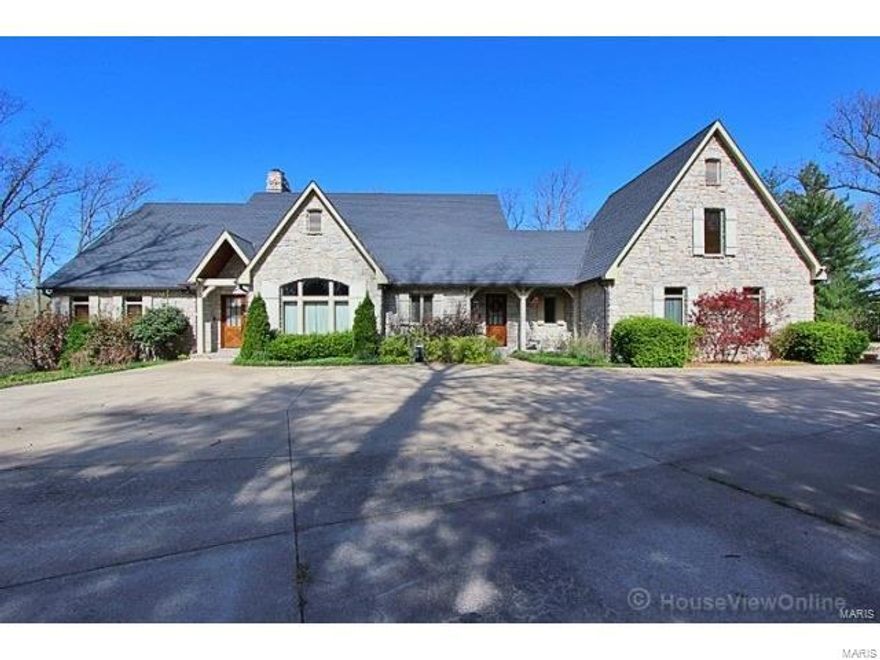 Luxury, Privacy, Charm!!!  This custom stone and brick house has over 7000 sq. ft. finished and sits on a park like setting of 4.5 acres.  The home has 4 bedrooms, 4 1/2 baths, a true gourmet kitchen and massive great room with a large stone fireplace.  The floors are custom American Cherry throughout.  The home has 3 fireplaces, an outdoor covered deck, extensive landscaping, and total attention to detail throughout.  The detached shop/garage has an ac/heated workshop, gardening room, and more storage.  This is a true one-of-a-kind special home.  The home is equipped with a whole house generator and gorgeous copper gutters have been added!  Don't let this one pass you by!! Additional Rooms: Mud Room