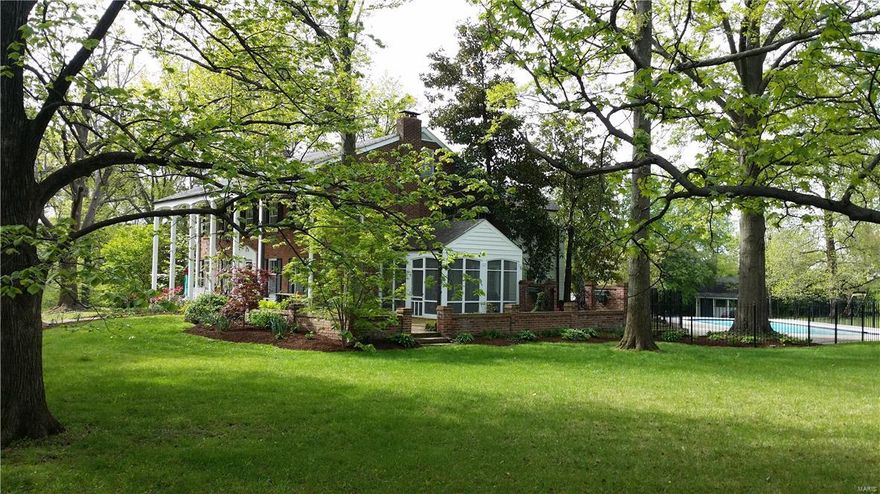 Adjusted Price of $100,000 creates Strong Value for this 2.5 acre picturesque home set in a handy Mid-County location.  Charming, classic Georgian colonial in one of the most secluded, private settings possible. 4300 Square Feet, composed of 4 BRs/4BA (Guest Suite on Main + 3 up)  The screened porch and patio adjacent to the front, forms a park-like environment leading to a 5-year old pool and deck. This is the perfect place for family gatherings, spring parties, evening cocktails or summer pool bashes. Rooms are generously sized and provide a flexible floorplan. The eat-in kitchen is completely open, and features Viking appliances, granite, island, and concrete countertops. Baths have all been updated, as well. Gleaming wood floors. Only minutes to best shopping and highways and just a quick shot to the airport or downtown. The home offers a main level laundry. Walk-out lower level, partially finished, is a great rec room ideally set for billiards, TV and movies & games. Additional Rooms: Sun Room