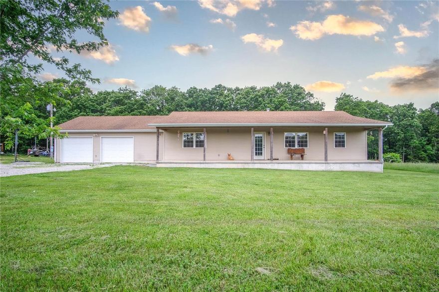 This nearly 30 acre tract of farmland has road frontage on 2 sides, is fully fenced, & is the perfect blend of woods to pasture, bringing 40+ bales in a good year. The winding driveway leads you to the 1700+sf, 3 bed 2.5 bath home which offers an open concept floorplan & split bedroom layout with the master suite on one side & the 2 guest rooms & bath on the other. The wide, country porch welcomes you inside where you'll find attention to detail in every room. There is a stand alone wood stove that will heat the whole house, a comfortable office area, dedicated dining area, & a large kitchen with a breakfast bar that can easily seat 6. Just off the garage/mudroom is a half bath with a plumbed in shower that just needs finishing. The pasture offers a frost free livestock waterer which is fed by the 400' deep well, a multi purpose 25X25 building, a wet weather creek, cut trails & lots of deer/turkey. This piece of paradise won't last - so call today to schedule YOUR private tour!