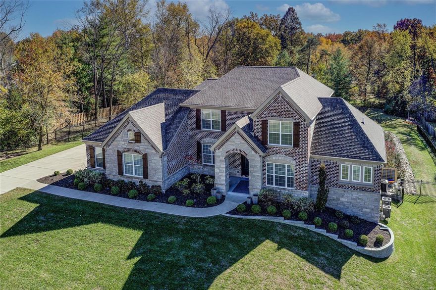 This sophisticated custom built home sitting on 1.25 acres, nestled into its own private enclave perfectly combines elegance and comfort. Enter the home through exquisite iron entry doors into the spacious foyer and study. The gorgeous kitchen with Thermador Professional appliances, exotic granite countertops and center island opens gracefully to the hearth and two story great room. Also on the main floor find the laundry, powder room and a romantic master suite featuring a beautiful glass pebble fireplace and a luxurious bath. Upstairs you will find 3 bedroom suites w/ walk in closets and a loft area. The finished walk out LL offers the 5th bedroom suite, 1/2 bath, rec area with stone fireplace, wet bar and barn doors leading to a bonus room with built in shelving. Enjoy outdoor entertaining with beautiful views and privacy from the deck leading to the patio w/ built in fire pit, overlooking the spa and salt water swimming pool. So much to appreciate, all within Ladue School District. Additional Rooms: Mud Room COOL: 14 SEER+