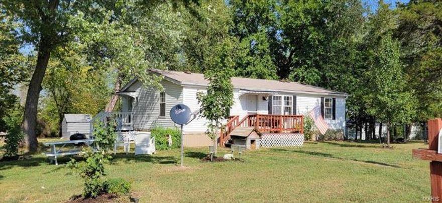 This 1400 sq ft home sits on just over 1/2 an acre with a big shaded yard and 30x16 workshop. the property has many upgrades such as New cabinets, flooring, some windows, doors, bathroom vanity's, and water filtration system. It has its own well, yet is also on public sewer. the yard is very spacious and has several large mature trees for all day shade. There is also a nice spot that is fenced in for the safety of your furry family members. The property is just far enough out to get away from the everyday hustle and bustle, yet is still on blacktop and just 15 mins. from town. Schedule your showing today!