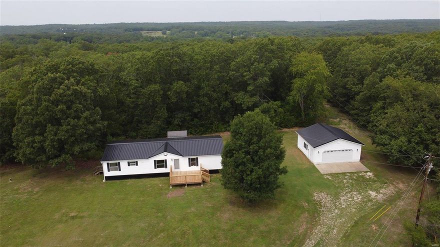 This gorgeous 4 bed ~ 2bath home is being offered on just over 4 acres...Home has been 100% redone to include a new metal roof on house and shop, new metal underpinning, new flooring, updated cabinets, brand new bathrooms, paint, trim, lighting, and so much more. Home features a large open floor plan, vaulted ceilings, large kitchen, custom wood beams, master suite that is split from other 3 bedrooms, separate dining, oversized front deck, screened in gazebo, and the best part a detached shop/garage thats finished with plywood, concrete floor, well lit, and extra outlets and power. This property is private, serviced by its own well, and is ready for its new owner! Don't miss your chance, call today!!