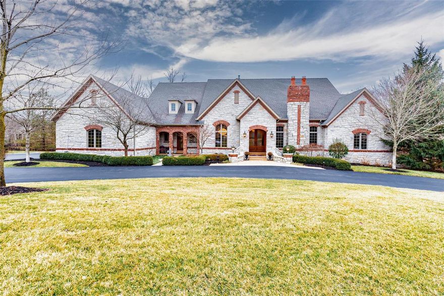 Magnificent European-inspired Estate home! DeShetler-built 1-sty with over 7200 sf of living space enhanced by wide plank oak flooring, exquisite moldings, 12’ ceilings & arched entryways. Expansive marble foyer leads to private study surrounded by natural oak paneling & bookcases, elegant dining room & stunning great room with beamed cathedral ceiling & marble fireplace. Chef’s kitchen featuring cherry cabinetry, commercial grade appliances, butler’s pantry & convenient planning center adjoins sunlit breakfast room, hearth room with floor-to-ceiling stone fireplace & gathering bar. Coffered master bedroom suite with marble fireplace, walk-in closet with 2nd laundry & lavish bath with shower spa & jetted tub plus 2 additional bedroom suites complete the main floor living quarters. Lower Level includes recreation room with wet bar, game room, workout room, 4th & 5th bedrooms w/ Jack n’ Jill bath & ½ bath. Extensively landscaped 1.8 ac lot, 2 imported fountains, 3 patios & 4 car garage.