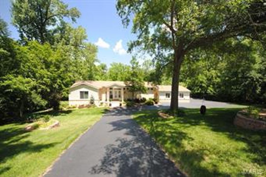 AWESOME renovation w/approx. $450K in updates! This sprawling Ranch on a 1.7 acre park-like lot backing to woods at the end of a private cul-de-sac, w/ 5 beds & 4.5 baths is impressive!  Asian mahogany hardwood & Turkish travertine tile throughout most of the upper & LL with heated travertine in the LL family rm & baths. Massive great rm with soaring cathedral ceiling, atrium walk-outs to the elevated 1100 sq ft deck & full masonry see-through fireplace that opens to the stunning eat-in kitchen w/huge center island, gorgeous granite counters, ample custom 42in cabinetry ($50K), high-end stainless appliances, slow close cabinetry, + drawer microwave.  Luxurious master suite w/ inviting private full bath w/double vanity, claw-foot jet tub & amazing over-size shower w/4 separate shower fixtures. Expanded LL functional space w/walk-out/look-out LL including a large family room w/wood fireplace & atrium walk-out + cinema room. Convenient circle drive & 3-car oversized garage!