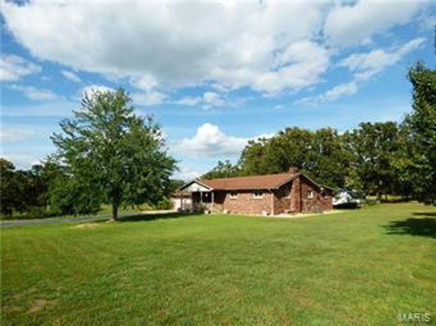 Beautiful well built home in Lebanon, MO.  This home sits on 20 acres, has a large pond and 2 large outbuildings, along with tons of yard to roam! Gorgeous quality wood work throughout home. From built ins in the spacious walk in closet, the beautiful hardwood flooring, sunroom hosts a wall of beautiful wood cabinets for storage... everything is gorgeous! Many, many updates! Complete remodel of master suite and extremely large bathroom also has a jacuzzi tub!. Beautiful open kitchen has lots of cabinets and countertops. All appliances stay with the home. Nice large sunroom with tons of light, to enjoy nature and the peaceful view also has entry to the back covered patio.  Full basement has large open area for rec room or den, bonus area and plenty of room to add another bedroom. Nice open land, home sits right on State Hwy 5 with long drive way to home, barn and shop. Shop has concrete floor & electric, large bay doors on front and side. All this and just inside city limits. Additional Rooms: Sun Room