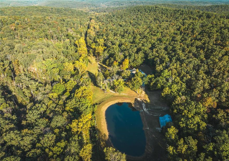 This 175-ac property stands as a testament to rustic elegance. Expansive landscape & miles of trails, this haven is a true delight for the outdoor enthusiast. As you traverse the property, you'll encounter a shooting range, 3/4-ac pond, stocked w/ largemouth bass, bluegill, & walleye. Creeks & awe-inspiring rock bluffs further enhance this natural retreat. Additionally, its adjacency to Meramec State Park ensures that the surrounding natural beauty remains preserved, adding to the overall appeal & desirability of the location. For the wildlife enthusiast, the property offers an exceptional opportunity for white-tail deer & tom turkeys, making it a haven for hunters. A 26x36 barn, with a loft, 200 amp service, concrete floor, provides ample space for storage. The centerpiece of the property is the updated rustic lodge-style home, boasting 5 beds 3 full baths, 3765 sqft & completely updated. This property is very close to the hospital, Schnucks, and CVS pharmacy, Lowes, and Walmart.