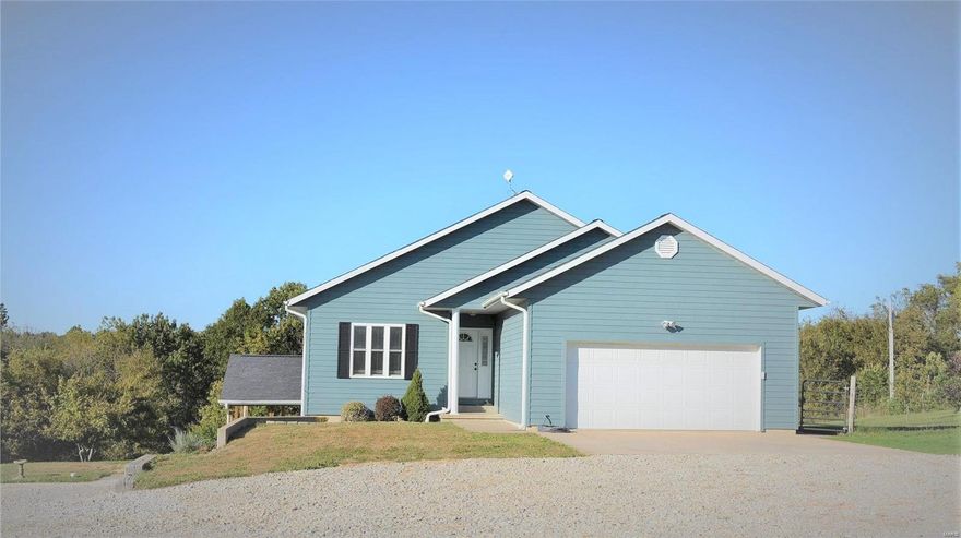 This beautiful home offers 5 bedrooms and 3 full bathrooms and sits on 4.2 acres. An open floor plan, beautiful hand scraped Acacia hardwood flooring, windows with marble window sills, vaulted ceilings.MAIN LEVEL - 3 bedrooms, 2 bathrooms, kitchen, dining room with sliding glass door to deck,living room, laundry room. The kitchen; new Samsung stainless steel appliances including a double oven gas stove, granite counter tops, breakfast bar, glass tile back splash. Main level; large master suite with walk in closet and updated bath with spa tub, separate shower, double sinks, marble top, new porcelain tile flooring.  LOWER LEVEL:walk out basement is partially finished and includes a living room, full bath, kitchen and 2 bedrooms. The basement offers an unfinished area and storage. The heating is all electric with a heat pump and offers propane back up. features: soft water system and a tank less on demand water heater and fencing for pets. Make your appointment today!