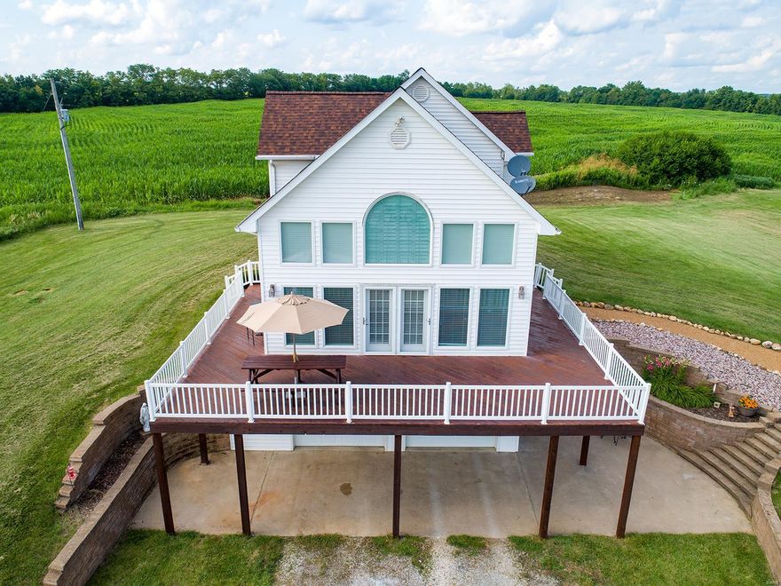 Very PRIVATE & SECLUDED 3 Bedroom, possible 4th BR, 3 full Bath 3,000 + SqFt Home with a PANORAMIC VIEW of over 107 acres of gently rolling  cropland (68 acres TILLABLE) meadows, wooded draws, walnut trees, trails, active food plots, a 3/4 ac stocked lake, a  SPRING FED CREEK w/pump house & an Amish built 40'x64' machine shed. NOW AVAILABLE & MOVE-IN READY!  Incredible 552 SqFt wrap-around deck, a 20 foot Vaulted Great Room, a handy 8'x3' Kitchen Island & Mannington Brand Vinyl Plank Flooring! Explore nature, the abundant wildlife, hunt, fish or just enjoy your privacy! This beautifully maintained property is definitely YOUR RETREAT, a family favorite for a weekend get-away, a vacation home or year round living with income producing tillable acreage! IMAGINE yourself on the huge deck entertaining family & friends or just relaxing while quietly watching a sunrise or sunset, wildlife at play or the moon & stars far away from City lights & noise. Just a short drive down your private lane! Some Accessible Features Additional Rooms: Sun Room