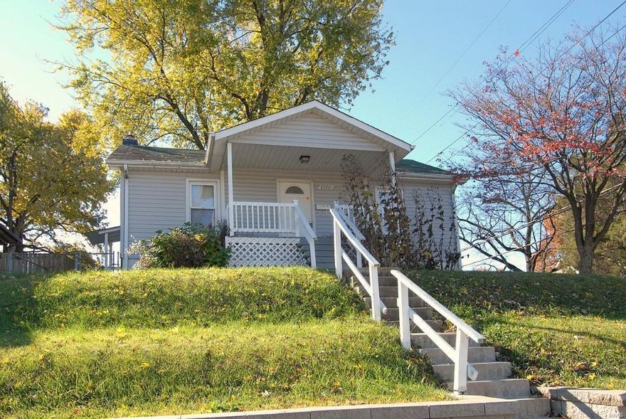 Charming Overland bungalow on corner lot could be your next home or income property. 3 bedrooms, 1 bath. Hardwood floors throughout. Open concept living/dining room. Kitchen and bath have been nicely updated. Dishwasher in kitchen stays with the house. 1-car detached garage and new retaining wall alongside house on corner. Zillow gives a rental income of $850/month.  Close to public transportation, schools, shopping..what more could you want for the price? Seller prefers to sell 'as-is.'